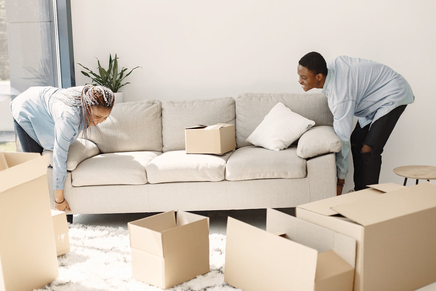 Universal Moving Services movers wrapping furniture